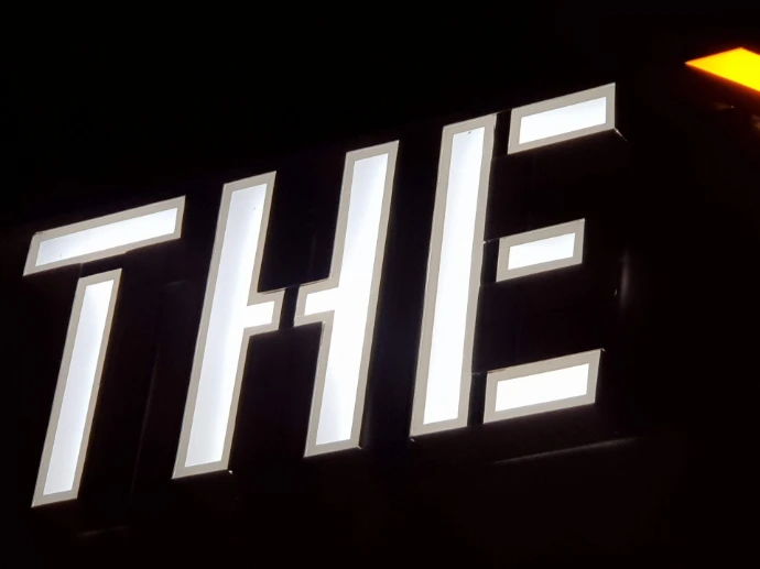 Frontlit 3D illuminated letters on black background