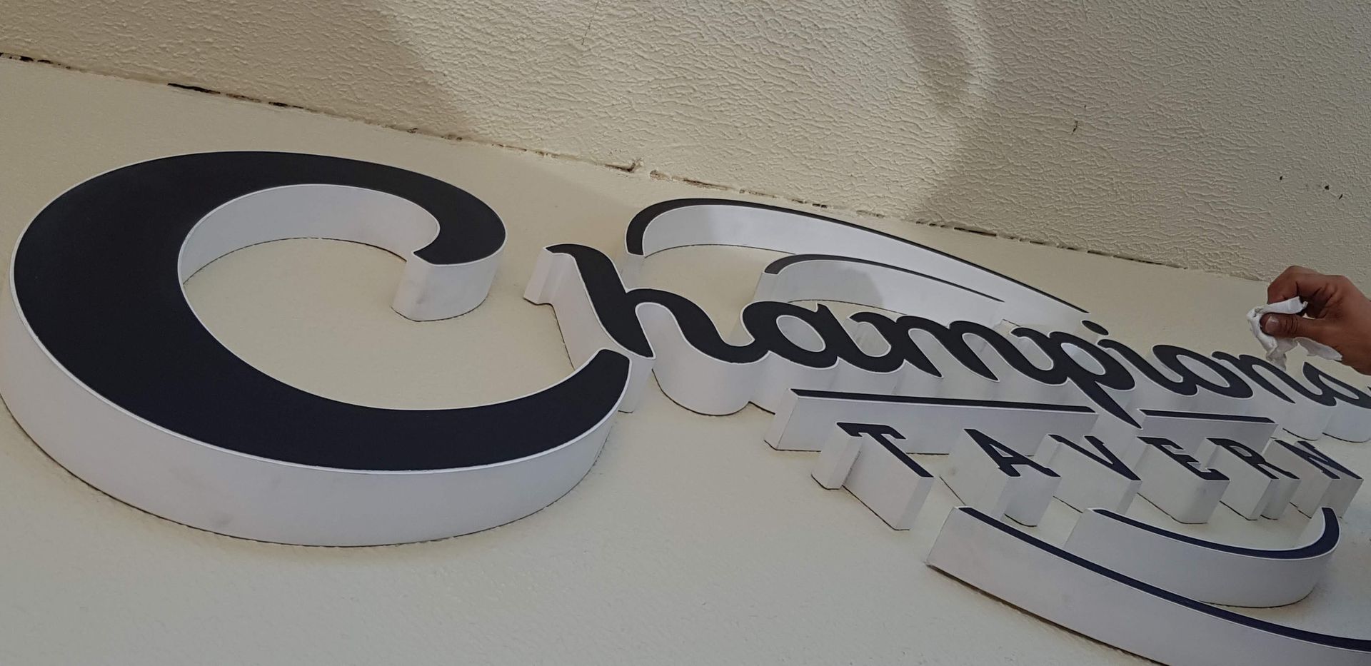 Custom illuminated signage being installed