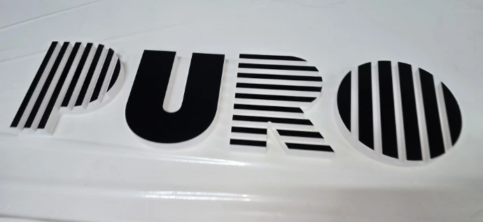 Die-cut PVC PURO lettering on white background