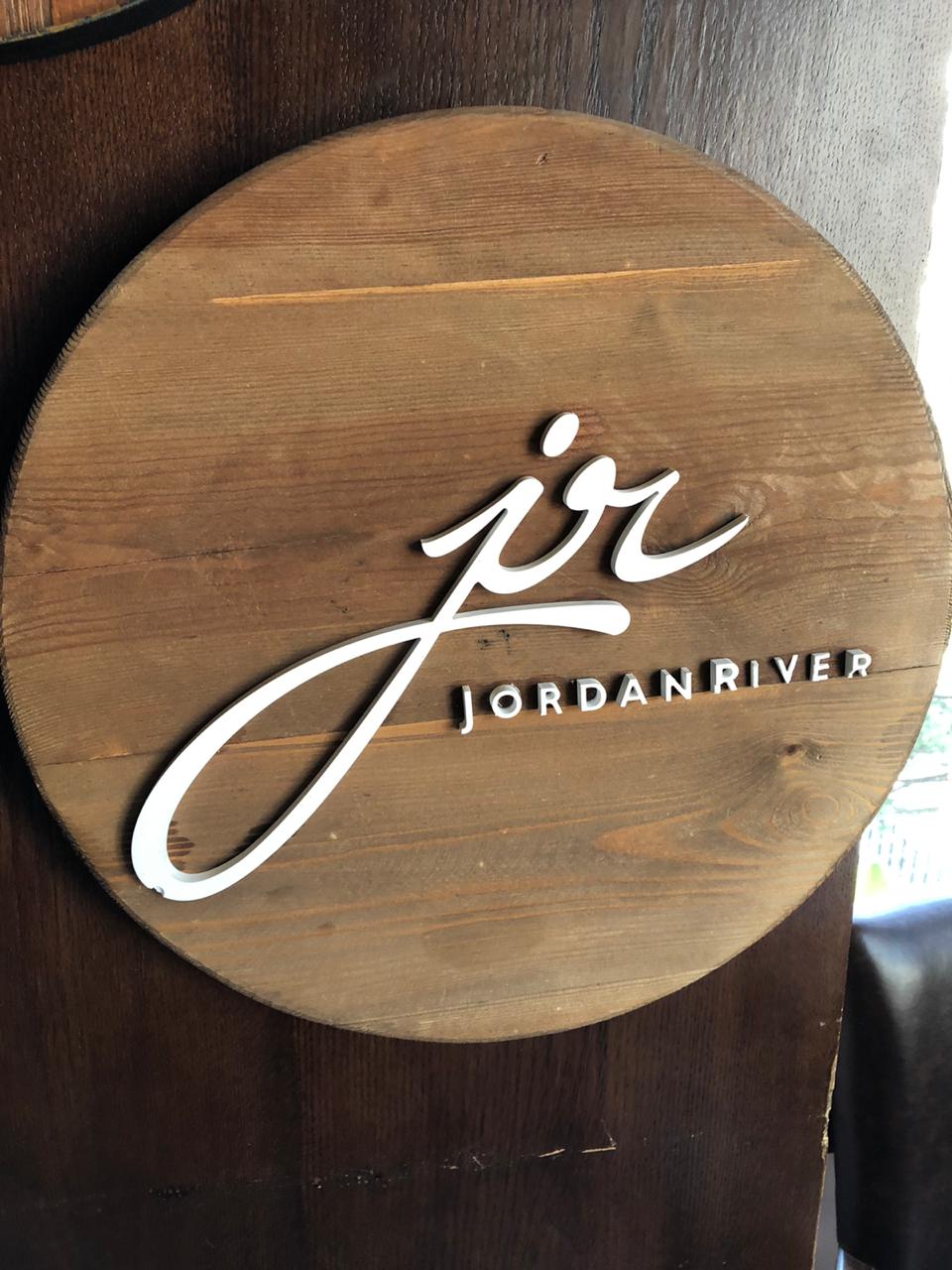 PVC logo lettering mounted on wooden Jordan River sign