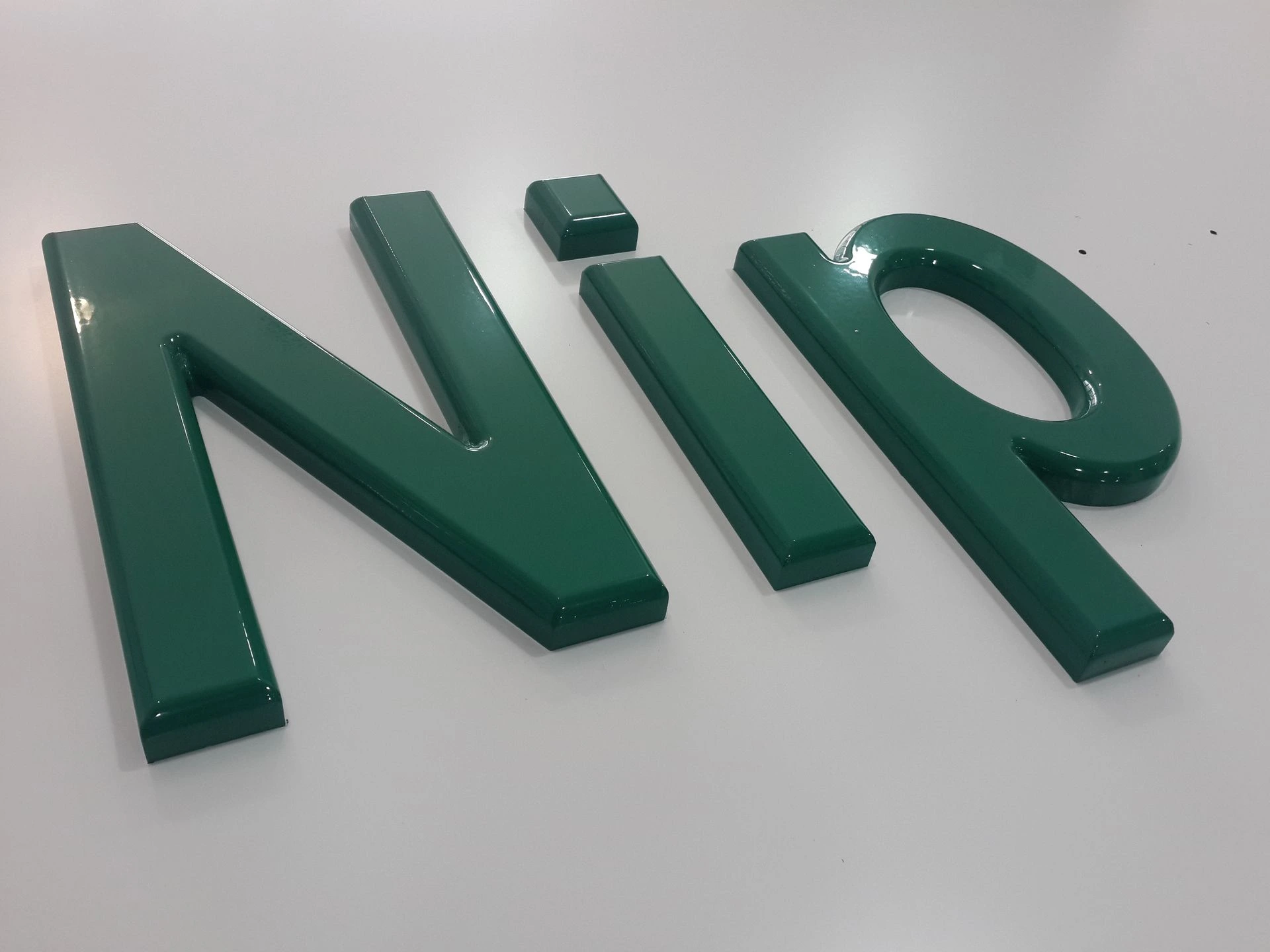 Close-up of green 3D PVC Nip letters