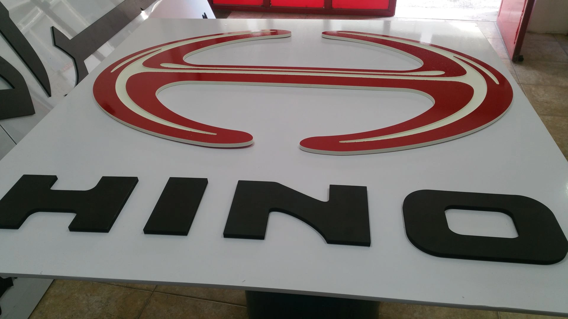 Die-cut PVC Hino logo during production