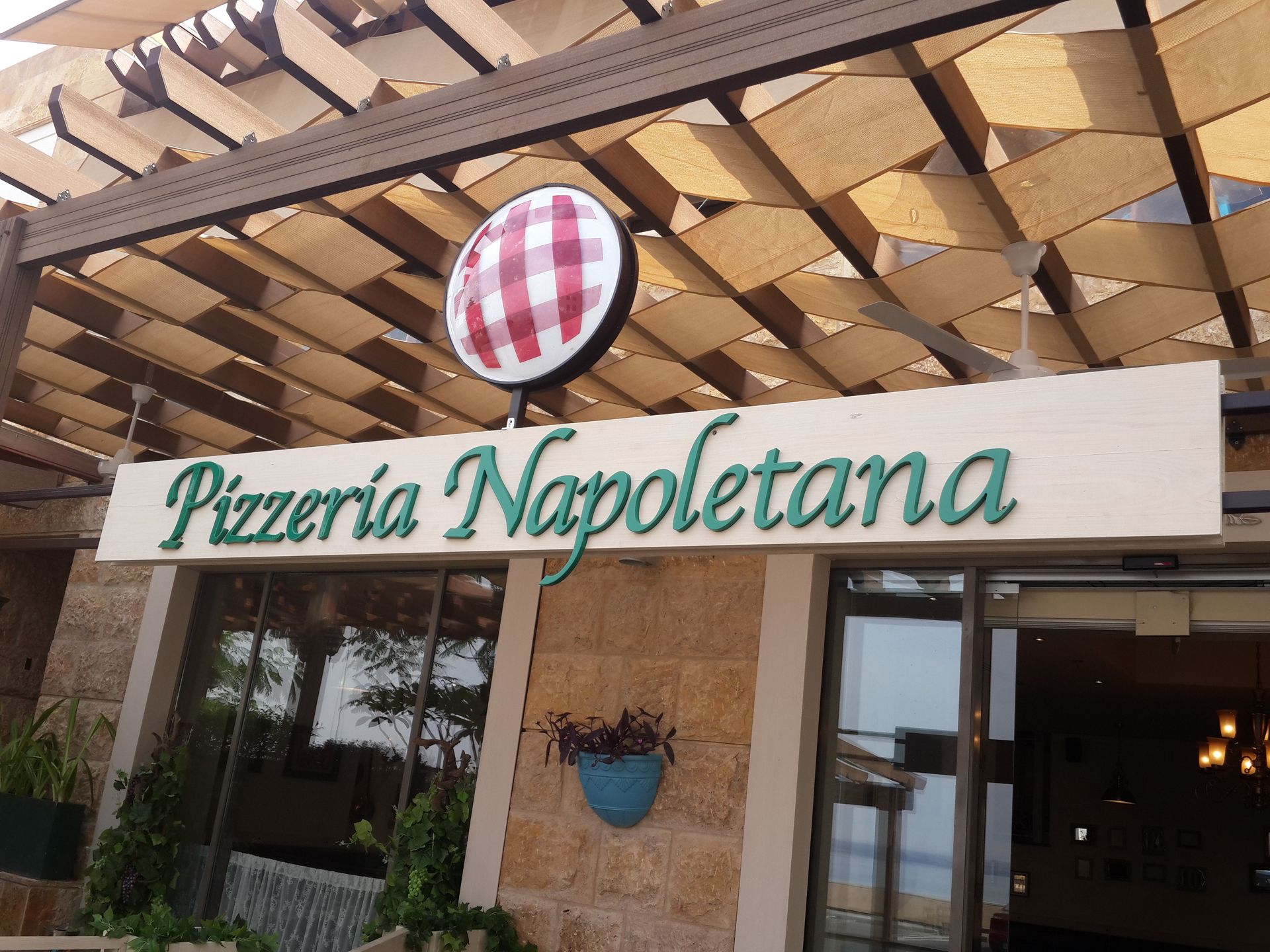 PVC Pizzeria Napoletana storefront sign above entrance